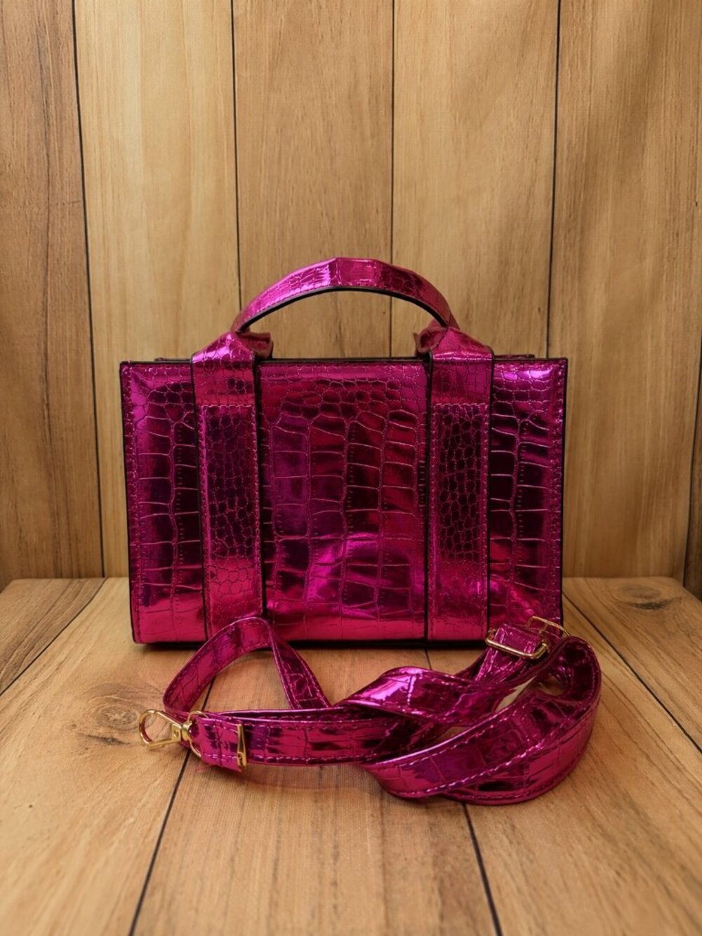 Small metallic hot pink structured handbag featuring a glossy crocodile-embossed